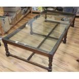 A rectangular glass top hardwood coffee table, W.190cm, D94cm, H.41cm