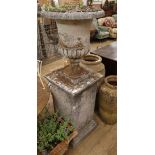 A reconstituted stone Campana garden urn, on square pedestal, H.161cm