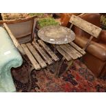 A circular marble topped and wrought iron garden table, together with two slatted garden chairs,