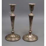 A pair of Edwardian silver candlesticks, James Deakin & Sons, Sheffield, 1907, 24.7cm, weighted.