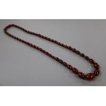 A single strand graduated simulated cherry amber bead necklace, 72cm, gross 61 grams.CONDITION: