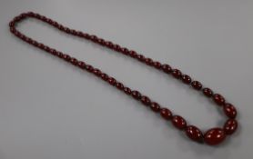 A single strand graduated simulated cherry amber bead necklace, 72cm, gross 61 grams.CONDITION: