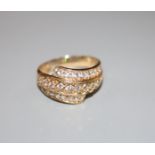 A modern 585 yellow metal and three row diamond set dress ring, size W, gross 5.2 grams.CONDITION: