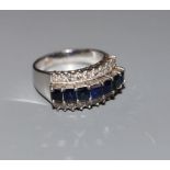 A modern 18k white metal and three row sapphire and diamond set dress ring, size O, gross weight 6.5