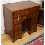 A George I walnut kneehole desk, W.82cm. D.44cm, H.81cm Condition report: Overall the colour is