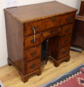 A George I walnut kneehole desk, W.82cm. D.44cm, H.81cm Condition report: Overall the colour is