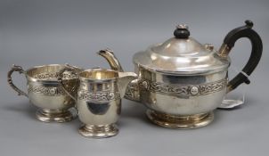 A George V Arts & Crafts silver three piece tea set, A.E Poston & Co Ltd, Birmingham, 1935, gross
