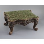 An American cast iron footstoolCONDITION: The upholstery is later, the iron frame paintwork is now