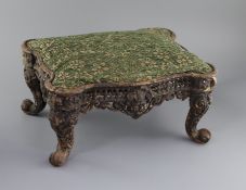 An American cast iron footstoolCONDITION: The upholstery is later, the iron frame paintwork is now