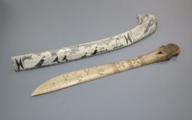 An eskimo scrimshaw elk bone and a similar paper knife, 22 and 23cm