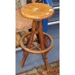 An early 20th century oak revolving bar stool, seat diameter 34cm. Condition report: The revolving