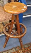 An early 20th century oak revolving bar stool, seat diameter 34cm. Condition report: The revolving