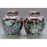 A pair of Japanese famille noire vases and covers, overall height 28cmCONDITION: One lid is badly