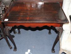 A George II style mahogany silver table, with dished rectangular top and acanthus carved cabriole