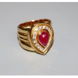 A modern 750 yellow metal, pear shaped cabochon ruby and diamond set dress ring, size N, gross 17.