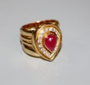 A modern 750 yellow metal, pear shaped cabochon ruby and diamond set dress ring, size N, gross 17.