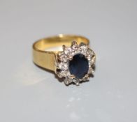 A modern 18ct gold, sapphire and diamond oval cluster ring, size M, gross 6.7 grams.CONDITION: One