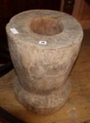 A carved wood mortar, H.55cm