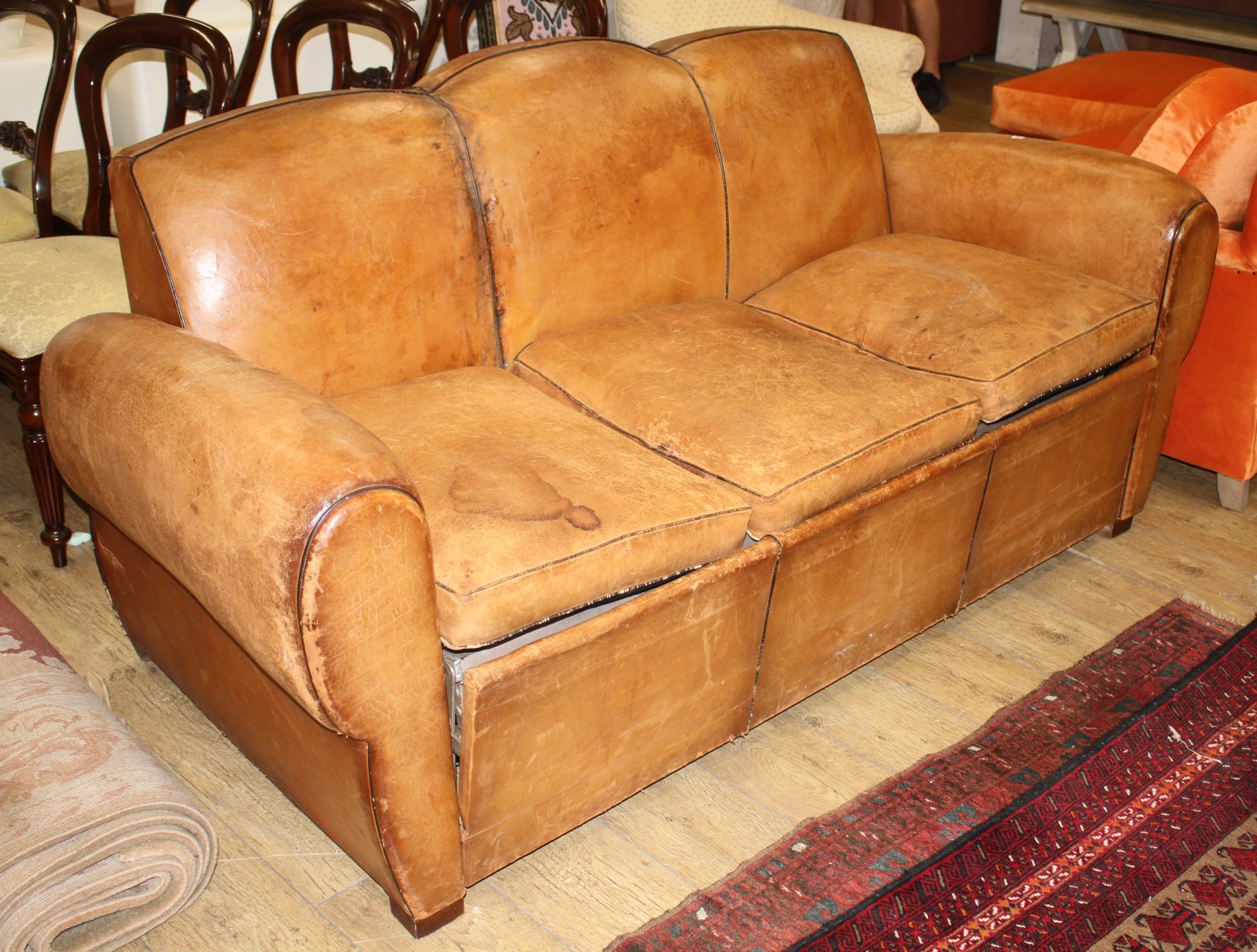 A French 1940's moustache back leather three seater sofa / sofa bed, W.188cm D.88cm H.89cm