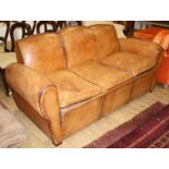 A French 1940's moustache back leather three seater sofa / sofa bed, W.188cm D.88cm H.89cm