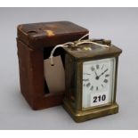A brass mounted carriage timepiece and case