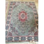 A Persian design machined green ground rug, 200 x 140cm