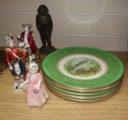 Three porcelain figures and eight plates, and a resin figure of a diver, etc.CONDITION: The figure