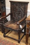 A pair of carved oak 'Wainscot' chairs, W.60cm, D.60cm, H.110cm