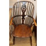 A 19th century ash and elm Windsor elbow chair Condition report: The wheel splat possibly re-