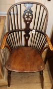 A 19th century ash and elm Windsor elbow chair Condition report: The wheel splat possibly re-