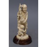 A Japanese ivory okimono group of a gentleman, a cockerel and a young boy, overall height