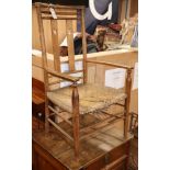 An Arts & Crafts rush seated beech elbow chair