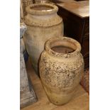 Two earthenware oil jars, largest H.92cm