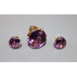 A modern 585 yellow metal and amethyst set dress ring, size M and a pair of similar 18k earrings.