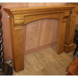 A reproduction oak fire surround, W.137cm H.110cm