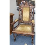 A late Victorian carved oak elbow chair