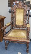 A late Victorian carved oak elbow chair