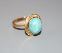 A modern continental yellow metal (tests as 18ct) and oval turquoise dress ring, size P, gross 3.2