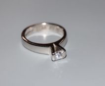 A modern 750 white metal and princess cut solitaire diamond ring, (stone chipped), size L/M, gross