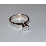 A modern 750 white metal and princess cut solitaire diamond ring, (stone chipped), size L/M, gross