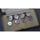 A set of four 18ct and plat, mother of pearl and diamond set dress studs and a pair of 9ct and