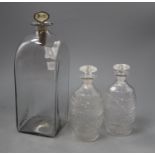 A tall early 19th century Dutch glass case decanter and a pair of cut glass barrel shaped spirit