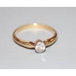 An 18ct and millegrain set solitaire diamond ring, size N, gross 2.5 grams.CONDITION: Stone size