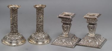 Two pairs of late Victorian silver dwarf candlesticks, Goldsmiths & Silversmiths Co Ltd, London,