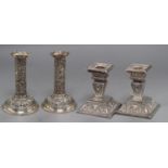 Two pairs of late Victorian silver dwarf candlesticks, Goldsmiths & Silversmiths Co Ltd, London,