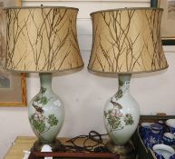 A pair of enamelled white glass table lamps, 82cm including shades