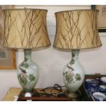 A pair of enamelled white glass table lamps, 82cm including shades