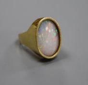 A modern 18ct gold and oval white opal set dress ring, size J, gross 8.4 grams.CONDITION: Stone