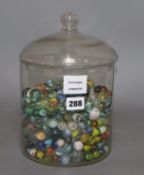 A glass jar and cover containing Victorian and later coloured marbles, height 26.5cm