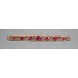 An early 20th century yellow metal and graduated pink tourmaline set bar brooch, 82mm, gross 6.4